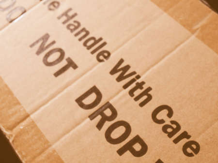 Fragile Handle with Care Do not drop label on a corrugated cardboard box vintageの写真素材