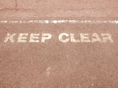 A traffic sign on asphalt street - Keep clear vintageの写真素材
