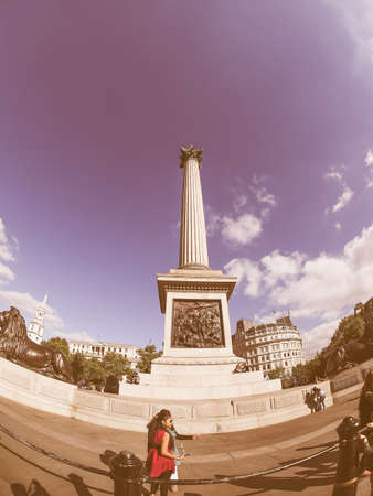 LONDON, UK - SEPTEMBER 27, 2015: Tourists in front of Nelson Column monument in Trafalgar Square vintageのeditorial素材