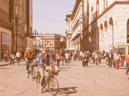 MILAN, ITALY - APRIL 10, 2014: Tourists visiting the Piazza Duomo square in Milan Italy vintage