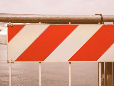 A traffic or a construction site sign in front of the sea vintageの写真素材