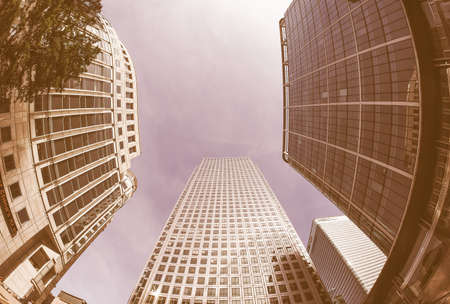 LONDON, UK - SEPTEMBER 29, 2015: The Canary Wharf business centre is the largest business district in the United Kingdom seen with fisheye lens vintageのeditorial素材