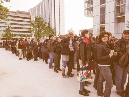 TURIN, ITALY - APRIL 11, 2015: People queueing to visit the new Intesa San Paolo skyscraper designed by Renzo Piano Building Workshop which just opened today and is the highest building in Turin vintageのeditorial素材