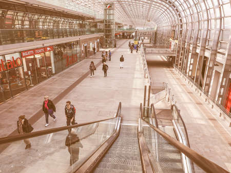 TURIN, ITALY - APRIL 11, 2015: The new Torino Porta Susa station is the main railway and subway station in town. Travellers in the main hall. vintageのeditorial素材