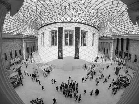 LONDON, UK - SEPTEMBER 28, 2015: Tourists in the Great Court at the British Museum designed by architect Lord Norman Foster opened in year 2000 seen with fisheye lens in black and whiteのeditorial素材