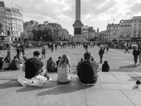 LONDON, UK - SEPTEMBER 27, 2015: Tourists in Trafalgar Square in black and whiteのeditorial素材