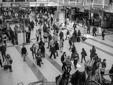LONDON, UK - SEPTEMBER 28, 2015: Travellers at Liverpool Street Station in black and white