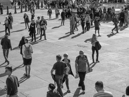 LONDON, UK - SEPTEMBER 27, 2015: Tourists in Trafalgar Square in black and whiteのeditorial素材