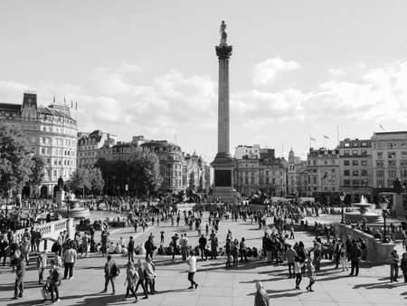 LONDON, UK - SEPTEMBER 27, 2015: Tourists in Trafalgar Square in black and white