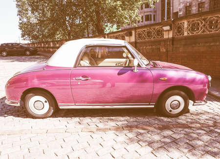 LONDON, UK - SEPTEMBER 28, 2015: Figaro is a small retro car manufactured by Nissan resembling the aesthetics of the sixties cars vintageのeditorial素材