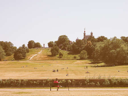 LONDON, UK - JUNE 11, 2015: Visitors at Greenwich park on Royal Observatory hill vintageのeditorial素材