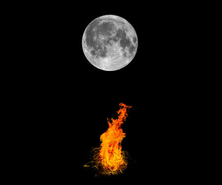 Full moon and bonfires burning bright in the night - dark black background with copy spaceの写真素材