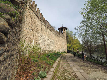 Castello Medievale (meaning Medieval Castle) in Parco del Valentino park seen from river Po in Turin, Italyのeditorial素材
