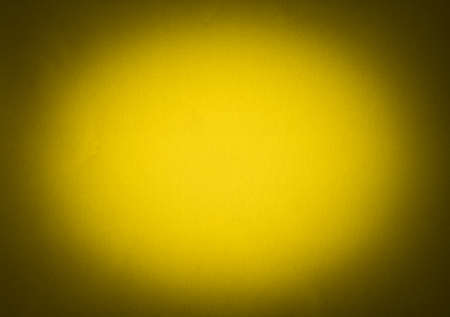 Yellow colour paper useful as a background vignettedの写真素材