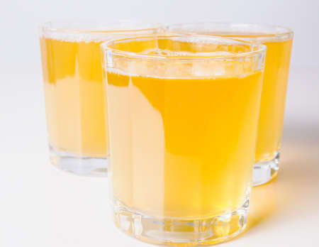 Glasses of pineapple juice on continental breakfast tableの写真素材
