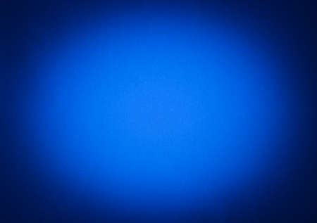 Blue colour paper useful as a background vignettedの写真素材