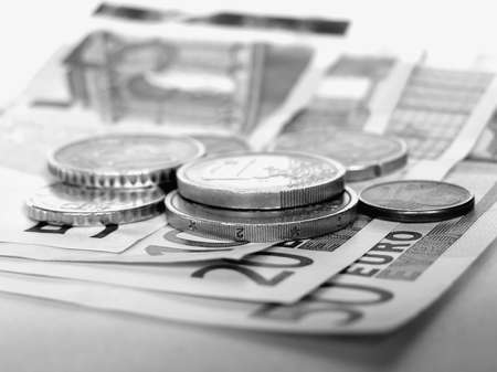 Euro banknotes and coins in black and white - Selective focus on coinsの写真素材
