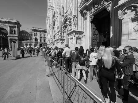 MILAN, ITALY - CIRCA APRIL 2016: Tourists queueing to visit Duomo di Milano (meaning Milan Cathedral) gothic church in black and whiteのeditorial素材