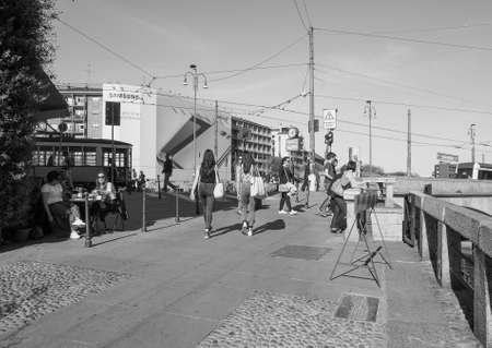 MILAN, ITALY - CIRCA APRIL 2016: Tourists on the bank of Naviglio Grande canal waterway in black and whiteのeditorial素材