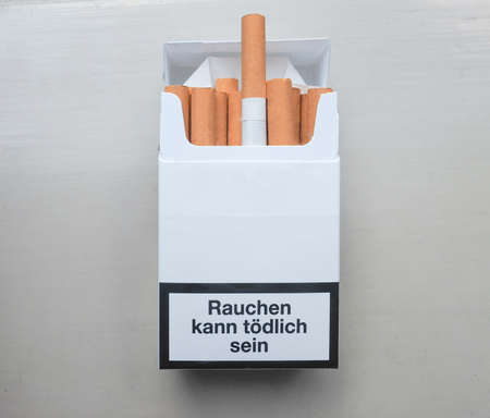 Rauchen schaedigt Ihre Lunge (meaning Smoking harms your lungs) written on a packet of cigarettes in Germanyの写真素材