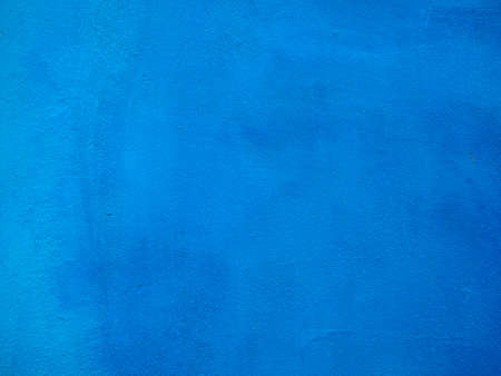 Blue painted plaster wall texture useful as a backgroundの写真素材