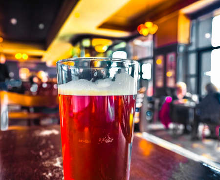 A pint of British ale beer in a pub, selective focus on glass with blurred background - high dynamic rangeの写真素材
