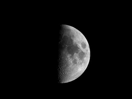 First quarter moon seen with an astronomical telescopeの写真素材