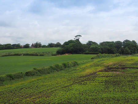 English countryside seen from a train near Liverpool, with selective focus on the horizon and motion...