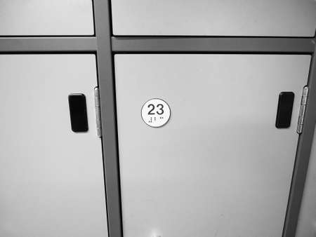 Lockers cabinets in a locker room at school or museum or station in black and whiteの写真素材