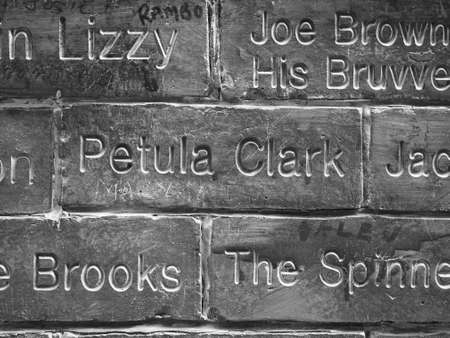 LIVERPOOL, UK - CIRCA JUNE 2016: The Wall of Fame at the Cavern Pub opposite the Cavern Club where The Beatles played. Detail of the Petula Clark tile. in black and whiteのeditorial素材