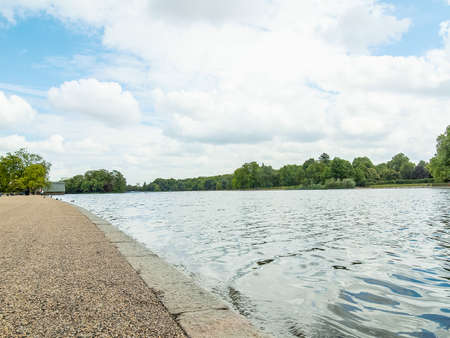 High dynamic range HDR Serpentine lake river in Hyde Park Kensington Gardens London UKの写真素材