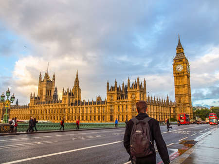 LONDON, ENGLAND, UK - OCTOBER 23: People crossing the world famous Westminster Bridge in front of the Houses of Parliament on October 23, 2013 in London, England, UK (HDR)のeditorial素材
