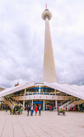 BERLIN, GERMANY - MAY 08, 2014: Turists visiting Alexander Platz, the central square in East Berlin, which was designed by German architect Peter Behrens (HDR)のeditorial素材