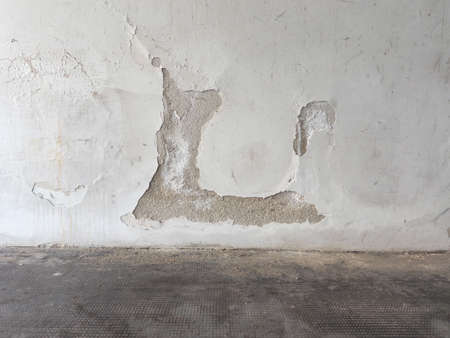 Damage caused by damp and moisture on a wall