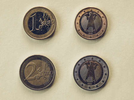 Vintage looking One and Two Euro coins currency of the European union common side and German side