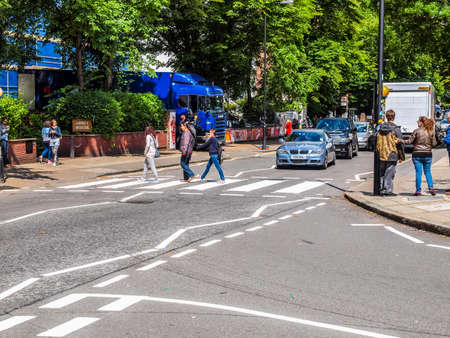 LONDON, ENGLAND, UK - JUNE 18: People crossing the Abbey Road zebra crossing made famous by the 1969 Beatles album cover on June 18, 2011 in London, England, UK (HDR)のeditorial素材