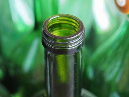 Detail of green open wine bottle neck, focus on bottle with blurred backgroundの写真素材