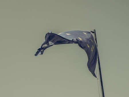 Vintage looking The national flag of European Union floating over blue skyの写真素材