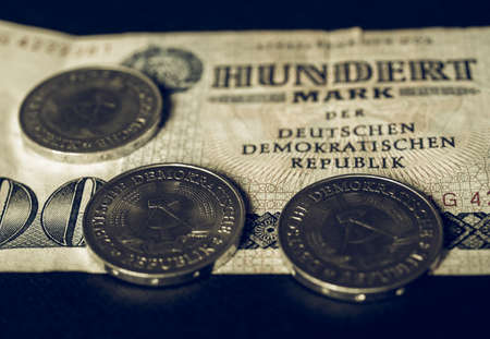 100 Mark banknote from the DDR (East Germany) with 1 Mark coin - Note: Vintage looking no more in use since german reunification in 1989の写真素材