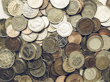 LONDON, UK - AUGUST 01, 2015: Vintage looking Euro and Pounds coins currency of European Union and United Kingdomのeditorial素材