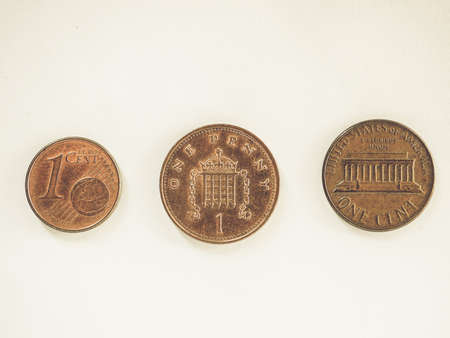 Vintage looking One Euro cent, one British Penny and one Dollar centの写真素材