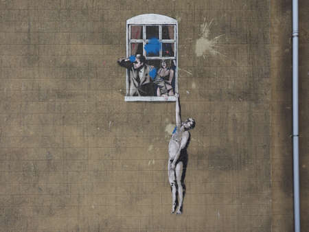 BRISTOL, UK - CIRCA SEPTEMBER 2016: Well Hung Lover graffiti by artist Banksy has been vandalised with blue paintのeditorial素材