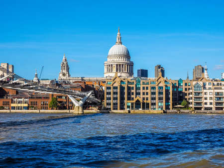 LONDON, UK - SEPTEMBER 28, 2015: People crossing the Millennium Bridge over River Thames linking the City of London with the South Bank between St Paul Cathedral and Tate Modern art gallery (HDR)のeditorial素材