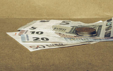 Vintage looking Euro coins and banknotes currency of the European Union - selective focusの写真素材