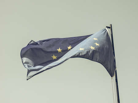 Vintage looking The national flag of European Union floating over blue skyの写真素材