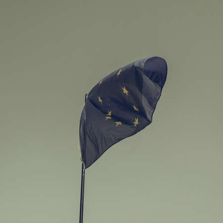 Vintage looking The national flag of European Union floating over blue skyの写真素材
