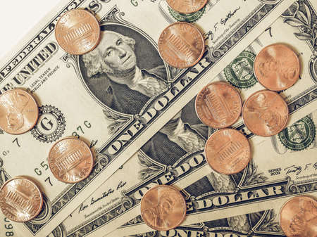 Vintage looking One cent coins and One Dollar banknotes  currency of the United States useful as a backgroundの写真素材