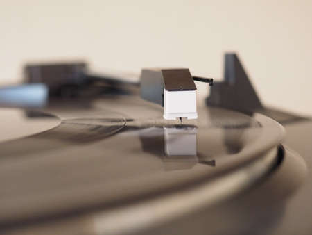 Vinyl record spinning on a turntable, focus on needle