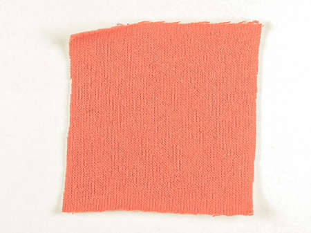 Vintage looking Red fabric swatch over white background