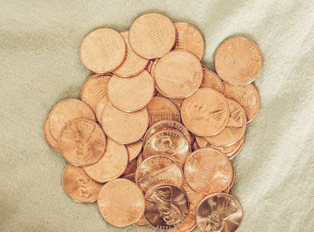 Vintage looking Dollar coins 1 cent wheat penny cent currency of the United States  over burlap backgroundの写真素材